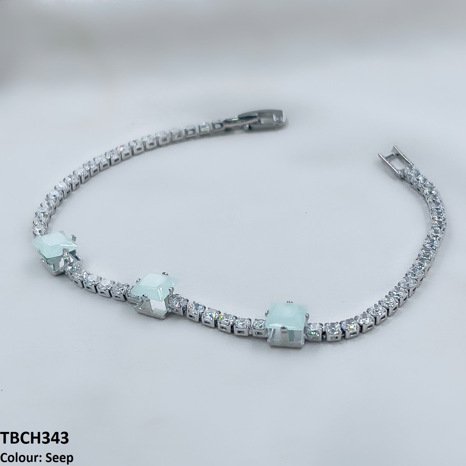 Detailed view of zircon square design on bracelet. 