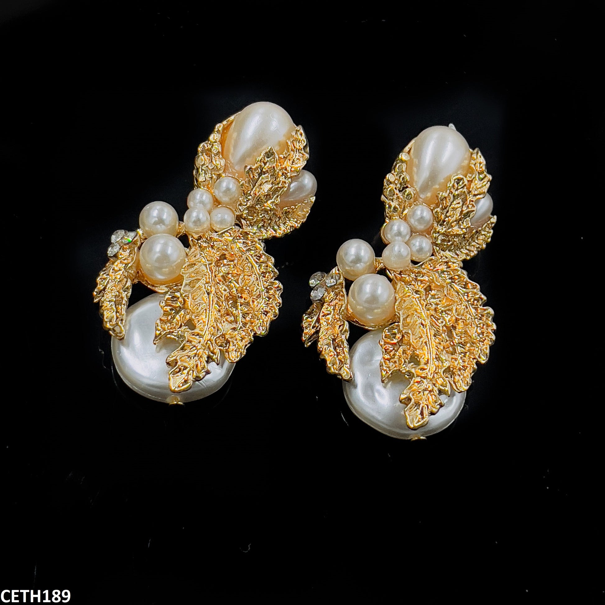 Elegant pearl earrings golden leaf design  
