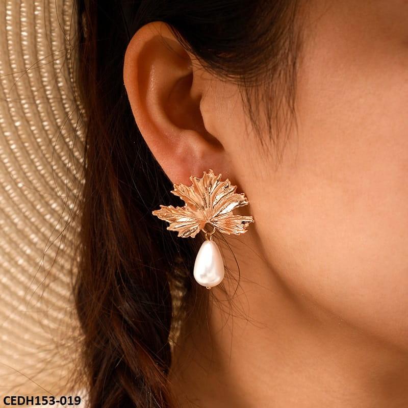 Pearl golden leaf pearl drop earrings close-up 